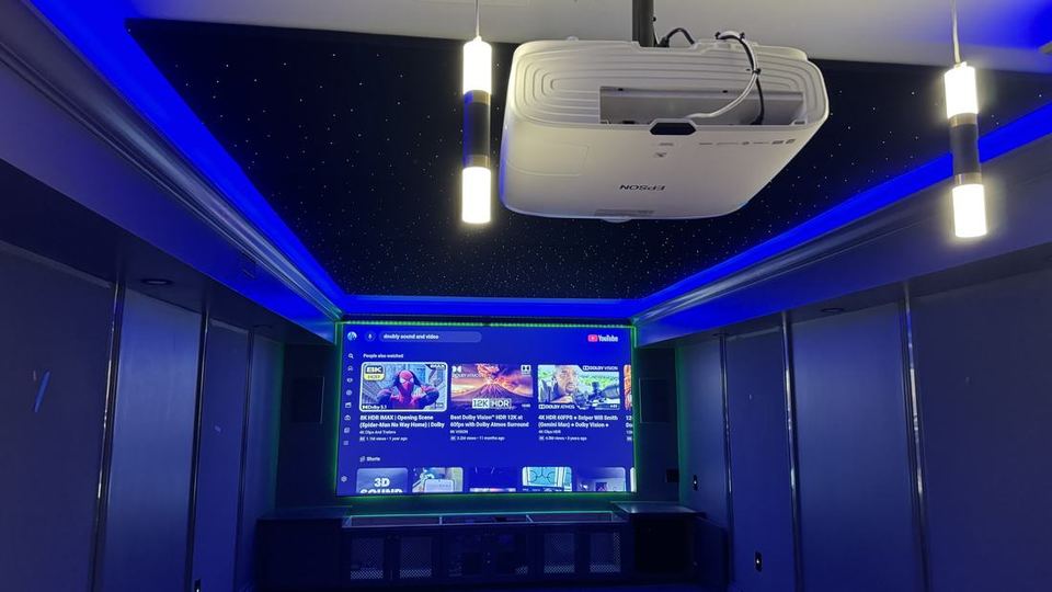 Home theater with a ceiling-mounted projector and starlight ceiling